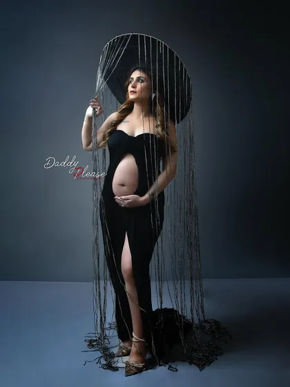 An avant-garde maternity portrait featuring a unique headpiece that simulates rain. This is a perfect example of the high-fashion, artistic concepts I love to create.