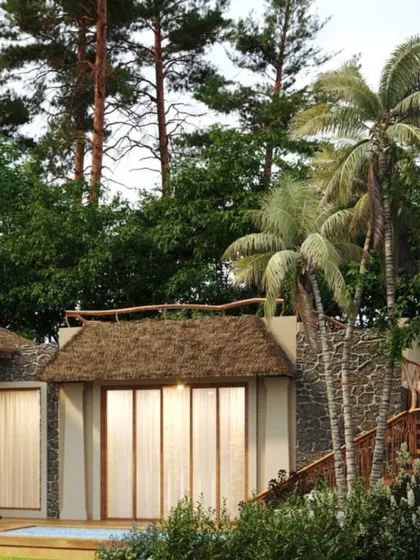 The architecture of Dev Villas in Kanha, surrounded by palm and pine trees. The use of thatched roofs and natural materials helps the buildings merge with the dense greenery.