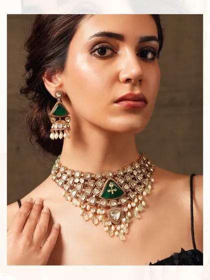 A triangular-motif necklace from the Emrosia collection, featuring large emeralds and cascading pearls for a unique bridal look.