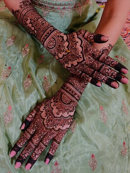 A crossed-hands view of the bridal design, highlighting the symmetry and the dense patterns.