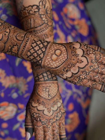 A unique angle of the engagement mehendi, showing the beautiful interplay of patterns on both hands.