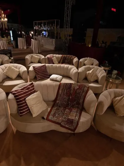A wide view of the guest seating area, showcasing the thoughtful arrangement of lounge-style sofas that encourage conversation and comfort, all while maintaining a luxurious aesthetic.