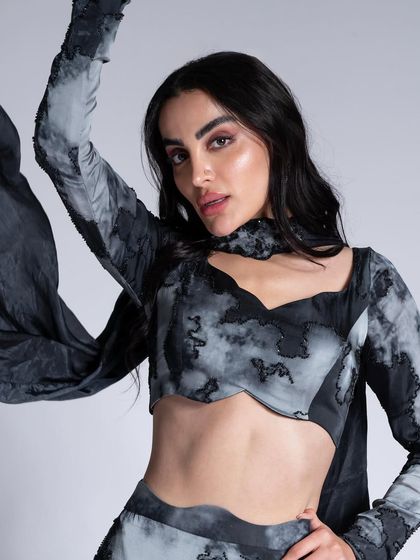 A monochromatic look with a tie-dye style print. The makeup is kept neutral with a soft brown smokey eye to balance the busy pattern of the outfit.