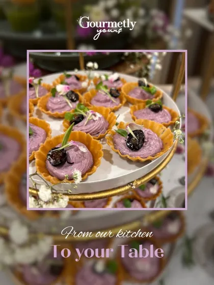 Delicate purple-hued tarts topped with blueberries and microgreens. This visually stunning appetizer showcases our creative use of color and flavor.
