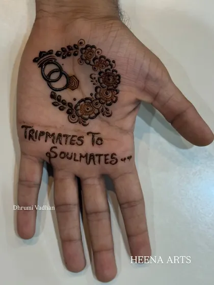 The second part of this groom's story. "Tripmates to Soulmates" is such a sweet summary of their journey, and the interlocking rings symbolize their union. It's these personal details that make groom mehendi so special.
