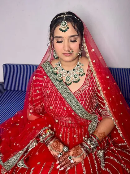 Radiant in red. This bridal makeup was crafted to complement her stunning outfit, with a focus on enhancing her natural beauty with a flawless base and defined eyes.