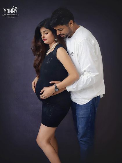 A gentle and loving embrace. This simple, elegant studio portrait of the couple captures the anticipation and love they share as they wait to meet their baby.