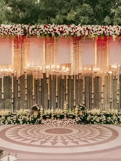 The sacred space where forever begins. We design breathtaking mandaps like this one, featuring a canopy of cascading florals and elegant lighting to create a truly divine atmosphere for your wedding ceremony.