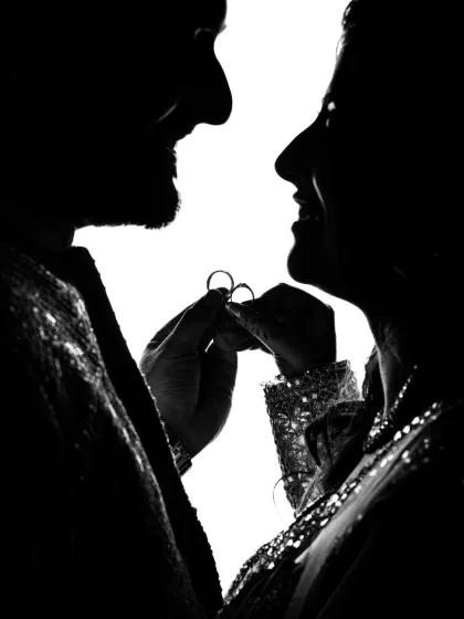 An artistic black and white silhouette of a couple holding their engagement rings. I love using creative techniques like this to produce unique and timeless couple portraits.