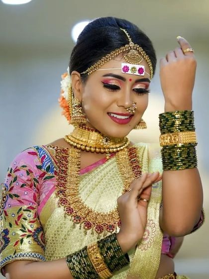 A playful pose highlighting the intricate bangles and the beautiful details of our rental jewellery set.