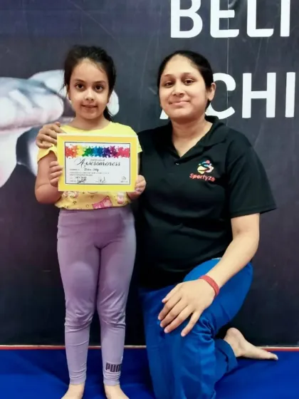 A happy moment between a student and coach celebrating a new certificate.