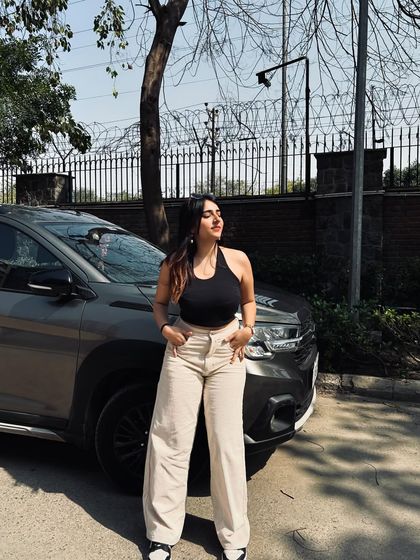 A classic combo of a black halter top and beige wide-leg pants. This is a timeless and versatile look that I love to style.