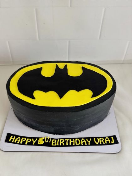 A bold and simple Batman logo cake, perfect for a fan of the Dark Knight.