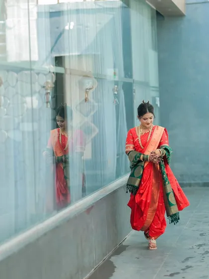 A candid shot of a bride walking, her full-arm mehndi reflected in the glass. It’s a beautiful, artistic way to capture the elegance of the design.