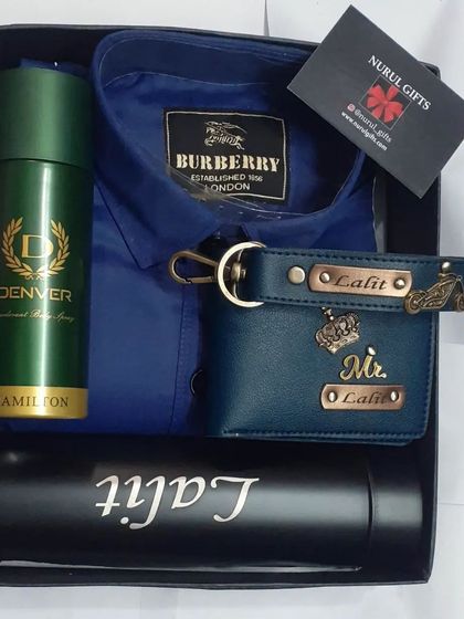 A blue-themed hamper with a Burberry shirt, a personalized wallet and keychain, a custom flask, and deodorant.