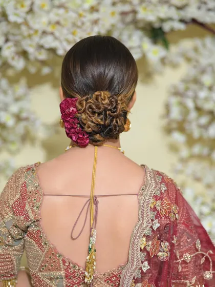 Another angle of the knotted bridal bun. This style is perfect for showing off the back of an intricate blouse, and it keeps the hair securely and beautifully in place.