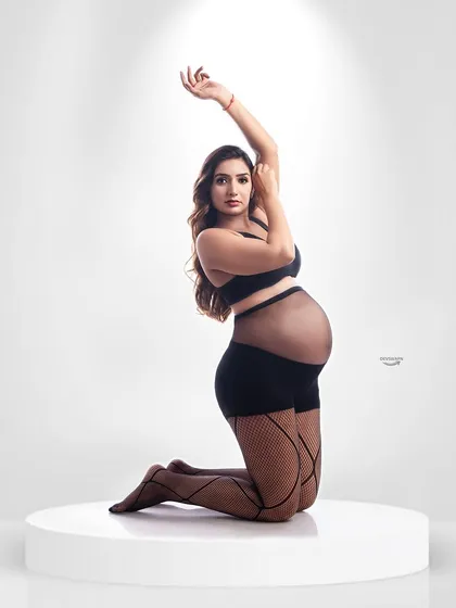 A striking and confident pose in a modern lingerie-style outfit. This type of portrait is for the client who wants to embrace her sensuality and strength during pregnancy.