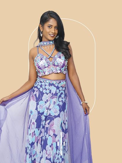 A fun and flirty floral co-ord set in shades of purple and blue. The embellished bralette and matching pants with a sheer cape give it a contemporary, resort-wedding feel. Perfect for a sangeet or a destination wedding party.