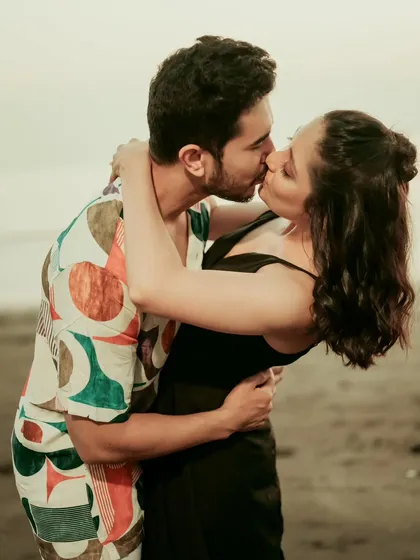 A passionate kiss on a Mumbai beach, capturing a raw and romantic moment. The warm tones and candid nature of this photo make it a powerful expression of love.
