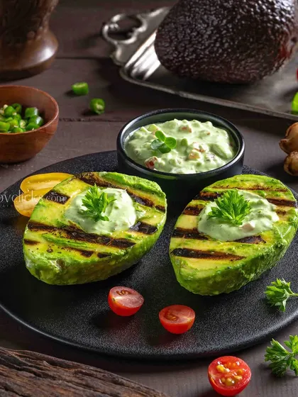 Grilled Avocado, a modern and healthy appetizer. The grill marks and creamy topping are the focus of this shot for The Mughal House.