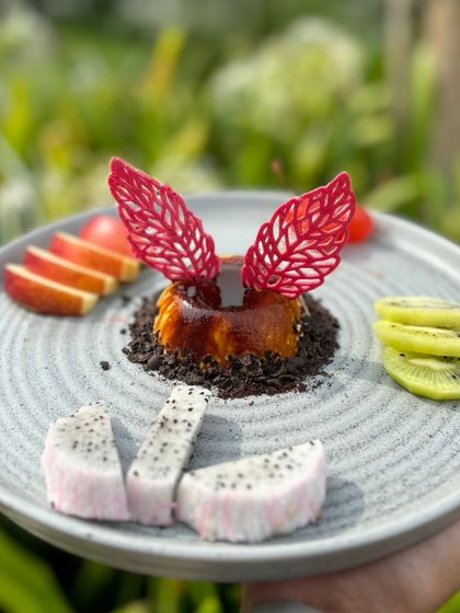 Our Filter Coffee Panna Cotta, beautifully presented with fresh fruits like apple, kiwi, and dragon fruit.