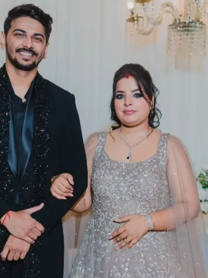 A classic portrait of the couple at their reception, looking elegant and happy in their stylish evening wear.