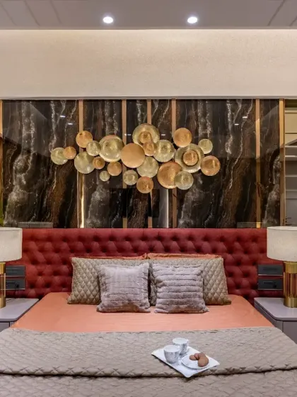 A duplicate of image 8, this image focuses on the striking combination of the red upholstered headboard and the dark marble wall, creating a luxurious and inviting ambiance.
