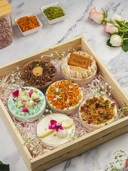 Our Fusion Globe Cakes are perfect for gifting or personal indulgence. This hamper-friendly assortment includes unique flavours like Thandai Cheesecake, Parle-G Tres Leches, and Pistachio Kunafa, beautifully presented in a wooden tray.