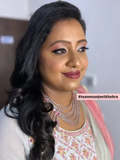 For her brother-in-law's reception, we went with a sophisticated glam look. I created a soft pink and mauve eye look with a winged liner and a deep mauve lip, which looked stunning with her diamond jewellery.