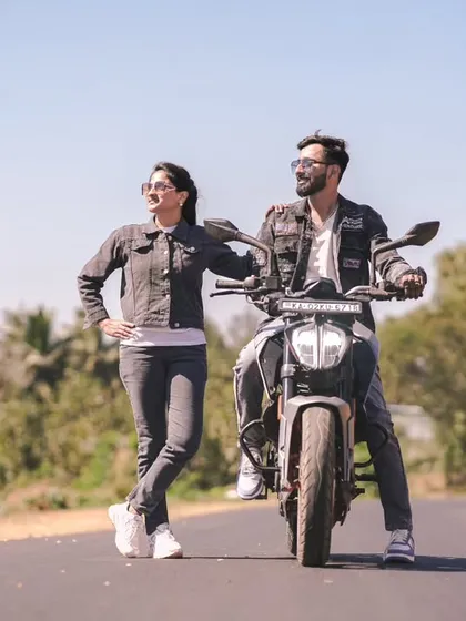 An adventurous pre-wedding shot on the open road with a motorcycle. Perfect for couples who share a love for bikes and the outdoors.