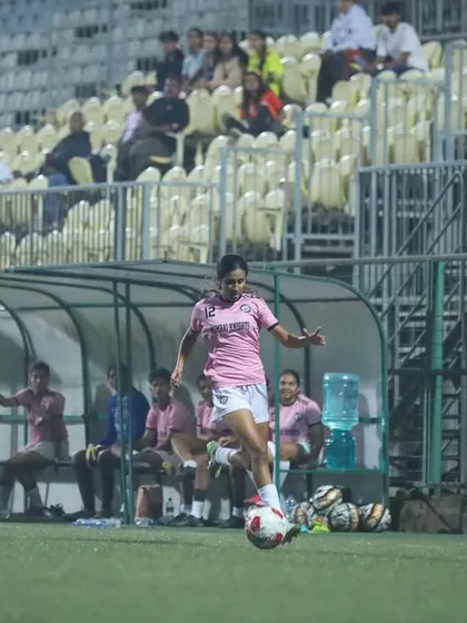 A player controlling the ball on the wing, looking to create an attacking opportunity.