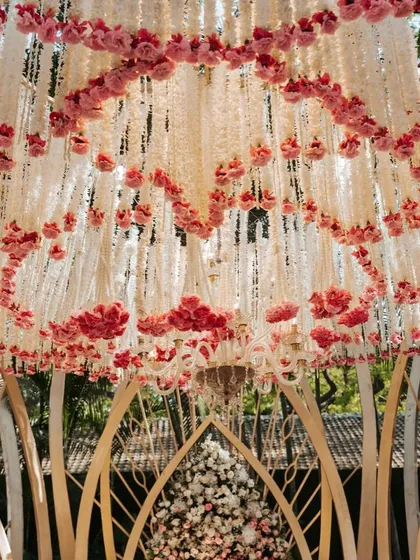 A view from below the Lotus Mandap ceiling, showing the intricate layers of hanging white and pink florals. This detail shot highlights the craftsmanship involved in creating this signature design.