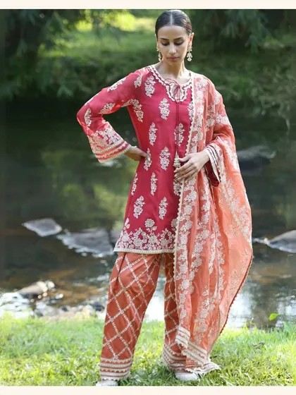 A beautiful red and peach kurta set that's perfect for the festive season. The combination of colors is so fresh and vibrant.