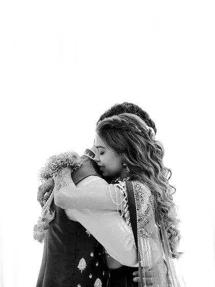 A powerful black and white shot of an emotional embrace. This image focuses on the raw feeling and connection, stripping away all distractions to show a moment of pure love.