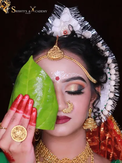 A creative portrait of a Bengali bridal look, featuring the traditional mukut, alta on the hands, and symbolic betel leaf.