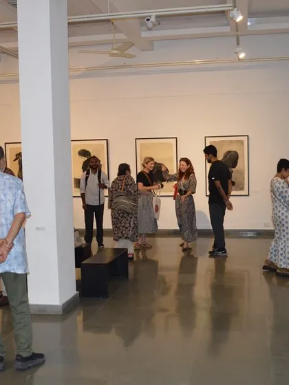 A group of guests enjoying the exhibition 'Quieter than Silence'.