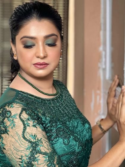 A close-up of the green smokey eye, showing the seamless blending and soft shimmer.