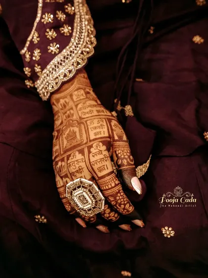 Another example of a gorgeous henna stain. The deep, dark color makes the intricate details of the design, including the Sanskrit verses, stand out beautifully.