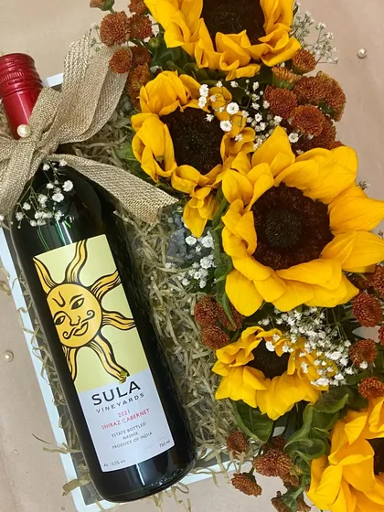 A box of sunshine for your sunshine. This gift combines a bottle of Sula wine with a beautiful bouquet of bright sunflowers.