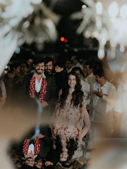 A creative shot of the couple's entrance, reflected in a mirrored surface for an artistic and memorable effect.