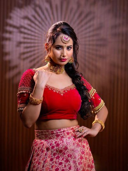 This series features a model in a red lehenga, wearing a simple but elegant gold-toned choker set. This is a great option for a pre-wedding puja or sangeet.