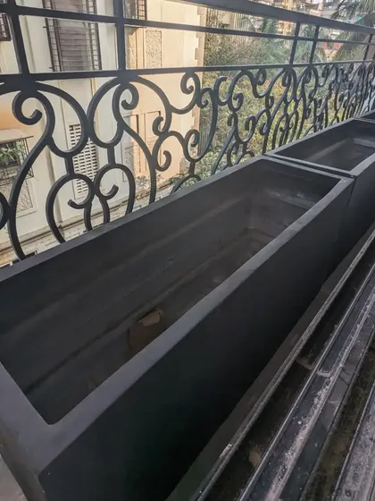 A look inside the empty FRP planters installed on the balcony. We use a geotextile layer and aggregate at the bottom to create a superior drainage system, which is vital for container gardening.