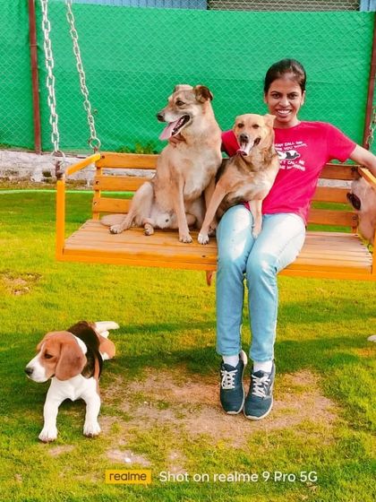 A happy pet parent visiting her dogs. We love it when families come to spend quality time in our playground.