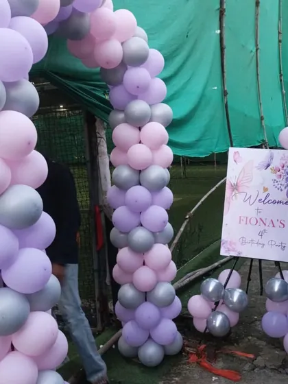 A simple and elegant balloon arch at the entrance to the butterfly-themed party, using a lovely lavender and grey color scheme.