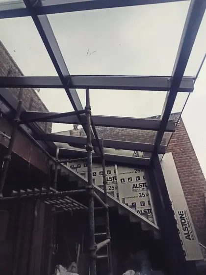 Another shot from the construction phase, showing the steel frame and initial glass panels being put into place. We believe the beauty is in the details, even during the build.