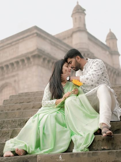 A tender moment on the steps near the Gateway of India. This close-up captures their deep affection for each other.