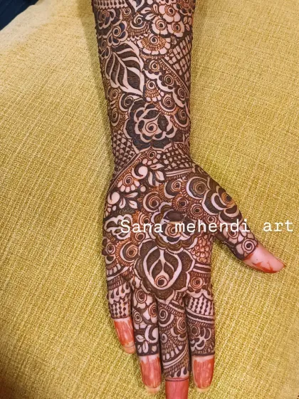 The palm view of the same full-arm bridal design, showcasing the dense floral and leaf patterns.