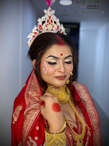 This close-up highlights the half-cut crease eye makeup, a modern technique applied to a traditional Bengali bridal look.