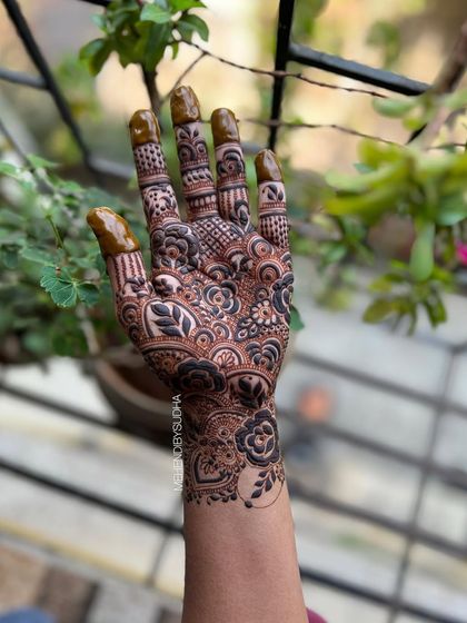 A creative shot of the single-hand design, held up against a natural background.