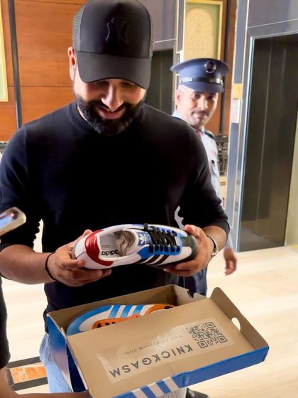 The "Hitman" himself, Rohit Sharma, holding the custom sneakers I created for him.